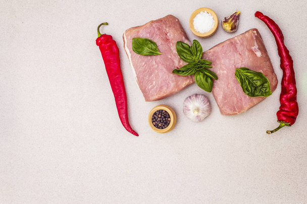 Raw pork meat loin with fresh vegetables and dry spice - Photo, Image