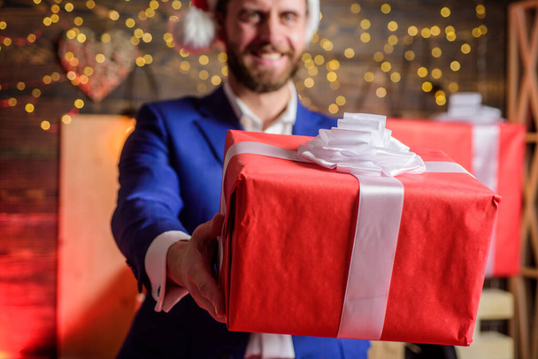 Man formal suit hold gift box. Christmas gift from colleague. Tradition giving gifts. Businessman excited face hold gift box. Secret santa office tradition. Celebrate christmas corporate party - Foto, Imagen