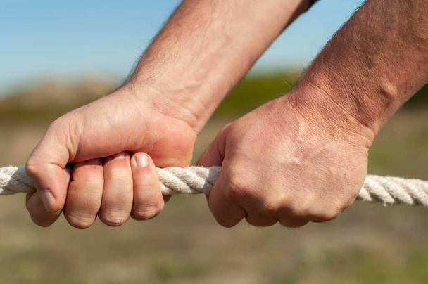 strong male hands hold the rope - Photo, Image