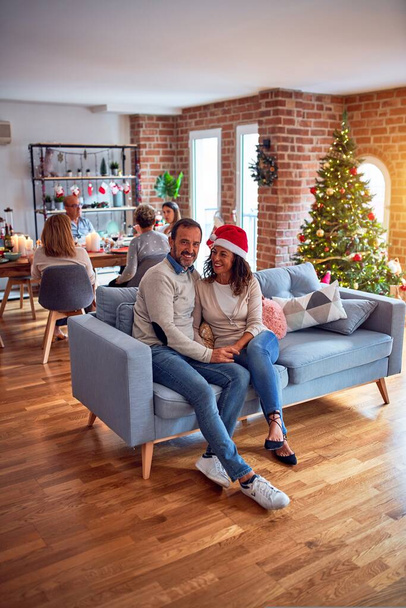Családi és baráti vacsora otthon ünnepli karácsony este a hagyományos ételek és dekoráció, romantikus idős pár beszélgetni együtt ül a kanapén - Fotó, kép