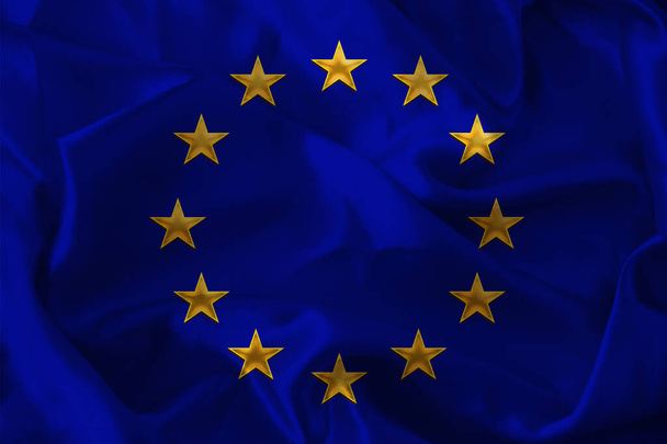 close-up photo of beautiful colored stylized European Union flag, symbol of united Europe on textured fabric, concept of tourism, emigration, economy and politics, close-up - Фото, изображение