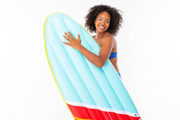 African woman in swimwear posing with air mattress against white background  - Photo, Image