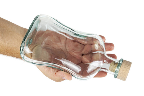 Hand holds an empty bottle with a cork. - Φωτογραφία, εικόνα