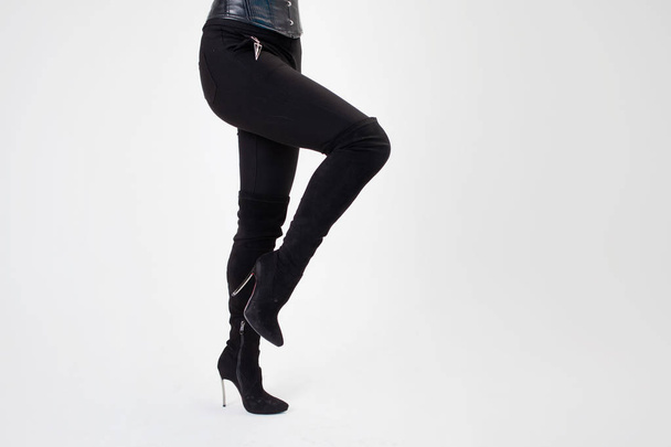 Slim legs in knee-high black boots. Sexy style, body parts on - Fotó, kép