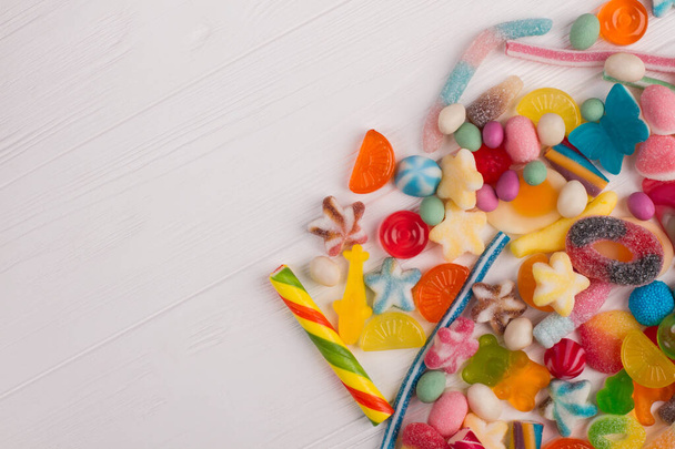 Sweet candies on white wooden background. - Φωτογραφία, εικόνα