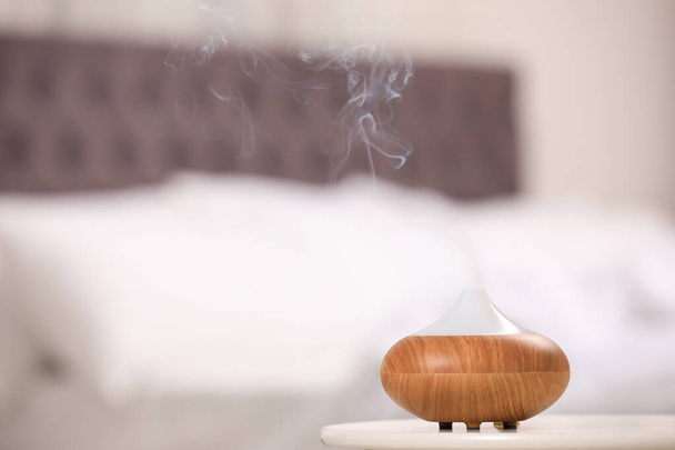 Modern essential oil diffuser on table indoors. Space for text - Foto, Imagen