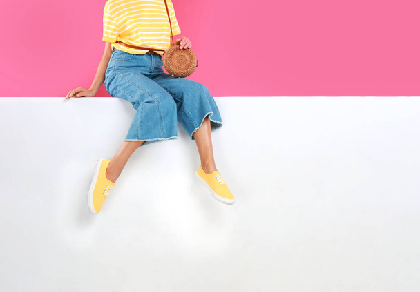 Woman wearing stylish shoes on color background, closeup - 写真・画像