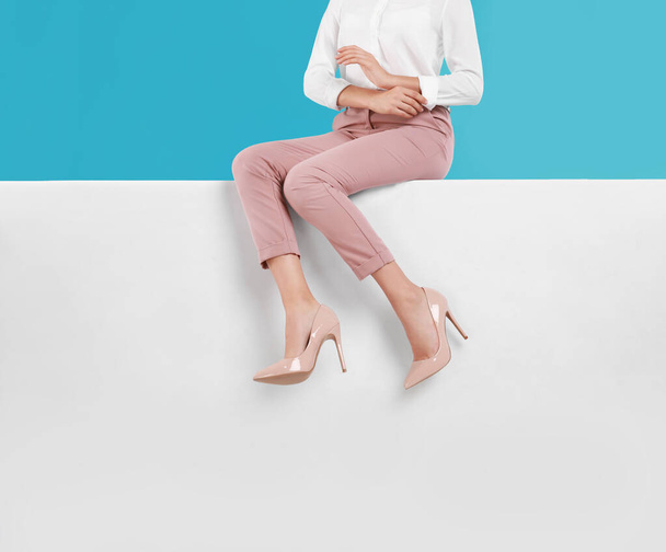 Woman wearing stylish shoes on color background, closeup - Fotoğraf, Görsel