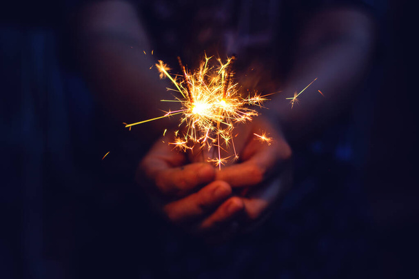 Christmas, New year sparkler in woman hands.  - Photo, Image