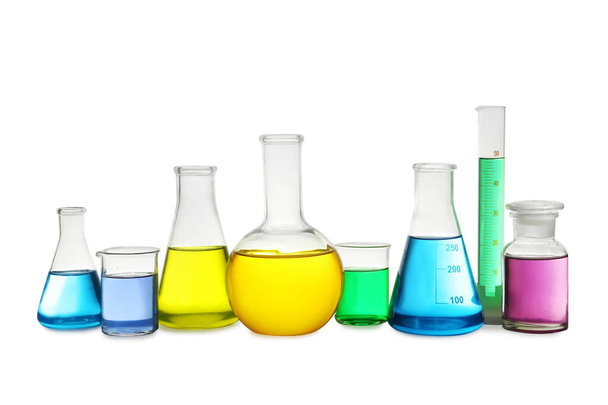 Laboratory glassware with colorful liquids on white background - Fotografie, Obrázek