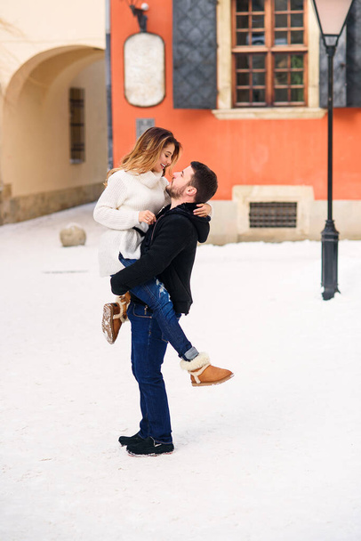 young loving couple on natural winter background. New Year and Christmas. - Photo, Image