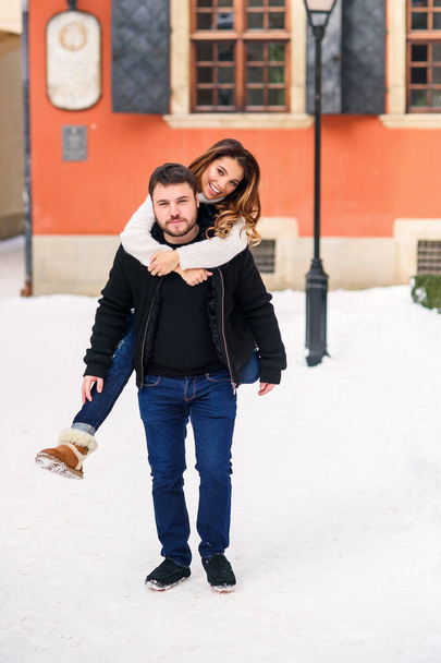 young loving couple on natural winter background. New Year and Christmas. - Fotó, kép