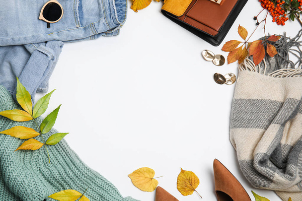 Warm clothes, autumn leaves and accessories on white background, top view. Space for text - Photo, image
