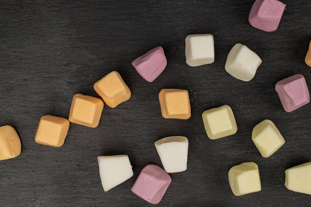 Soft pastel candy on grey stone - Foto, afbeelding