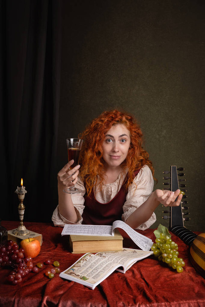 Red-haired girl in a historical suit plays the lute. Renaissance painting style - 写真・画像
