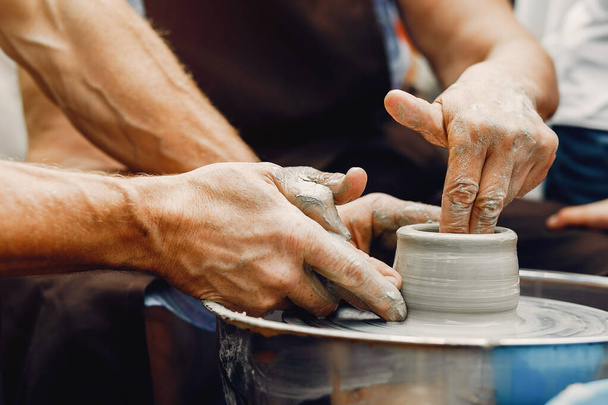 Grandmother with a grandchildren make pitchers in pottery - Zdjęcie, obraz