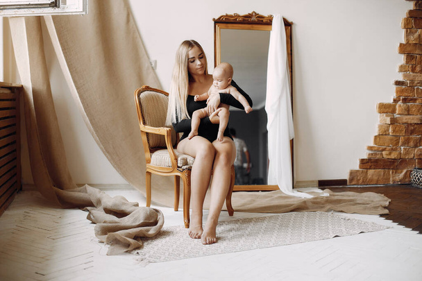 Elegant mother with cute little daughter in a studio - Fotografie, Obrázek