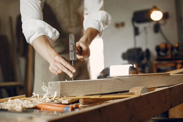 Handsome carpenter working with a wood - Valokuva, kuva