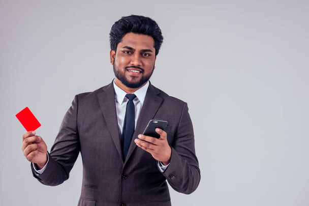 indian business man with credit card using mobile phone at studio white background,black friday sale - Foto, immagini