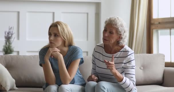 Stubborn young daughter ignore worried senior mother arguing nagging - Filmmaterial, Video