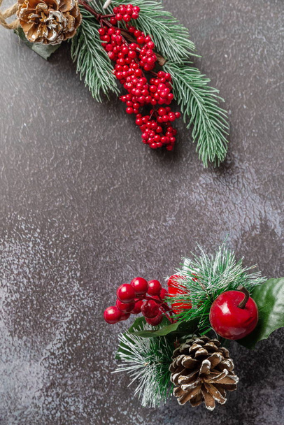 Christmas fir twig with berries on dark background - Zdjęcie, obraz