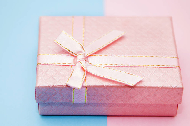 gift box on blue and pink background - Фото, изображение