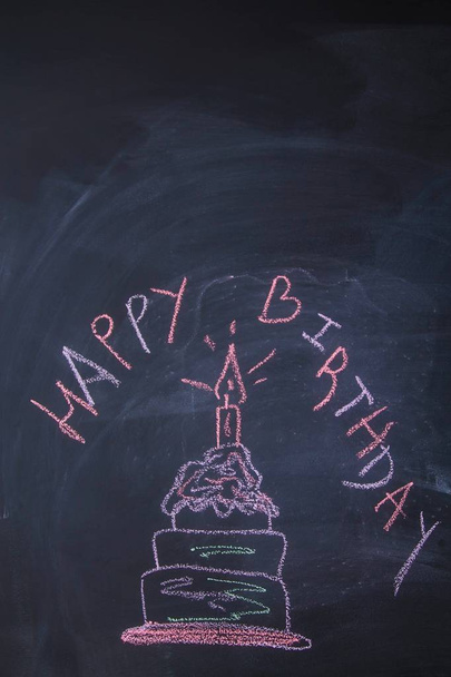 draw a birthday cake picture by chalk pastels on a school blackboard. - Photo, image
