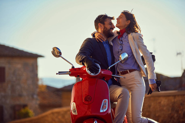 Young man and woman riding scooter. - Foto, imagen