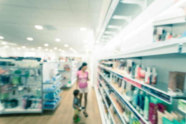 Filtered image blurry background customer shopping for cosmetics, makeup supplies at beauty store - Photo, Image