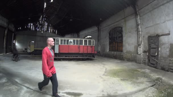 Muž kráčí Tanec ve staré továrně na vlaky - Záběry, video