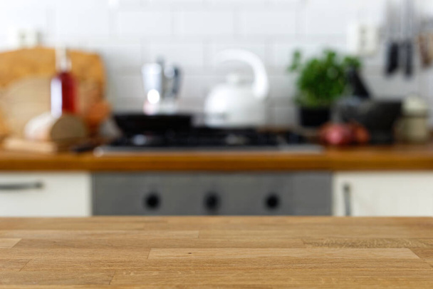 Empty wood counter in front of out of focus home kitchen backgro - Foto, immagini
