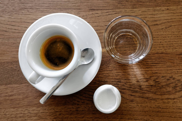 Classic italian single espresso in white cup, a milk jug and wat - Fotoğraf, Görsel