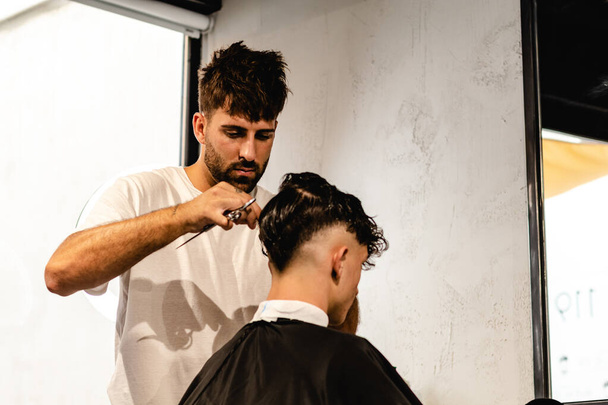Men Hair Salon. Barber Doing Haircut In Barbershop. Young Male Client And Hairdresser. - Photo, image