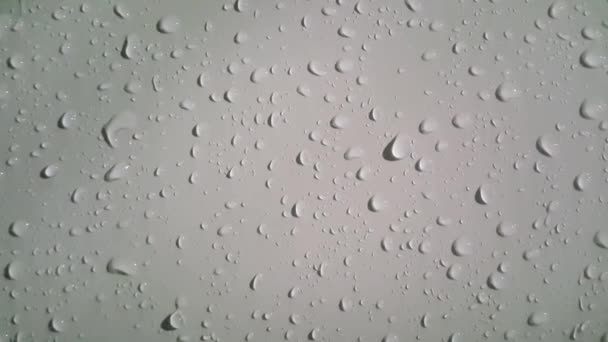 Closeup view of dripping water drops on grey silver color metallic wall - 映像、動画