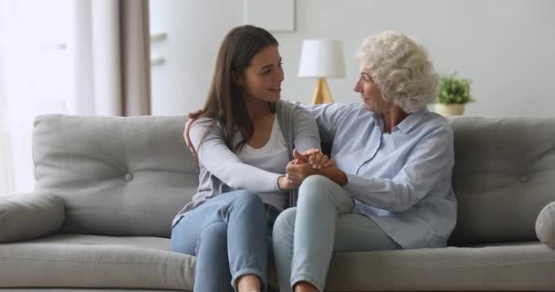 Happy young daughter and senior mother talking bonding at home - Felvétel, videó