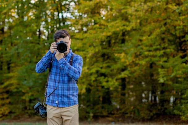 Professional photographer in action with two cameras on a should - 写真・画像