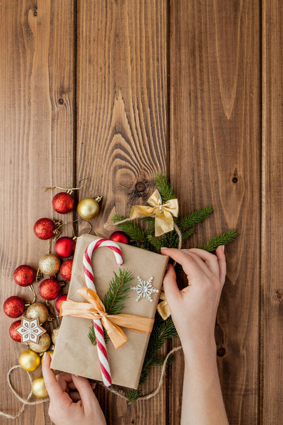 Woman s hands wrapping Christmas gift, close up. Unprepared chri - Фото, зображення