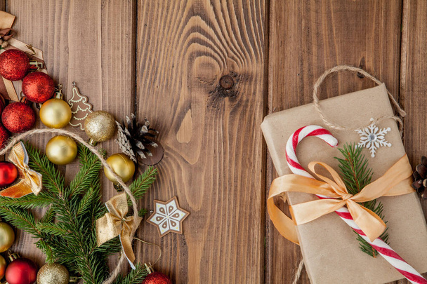 Christmas gift box, food decor and fir tree branch on wooden tab - 写真・画像