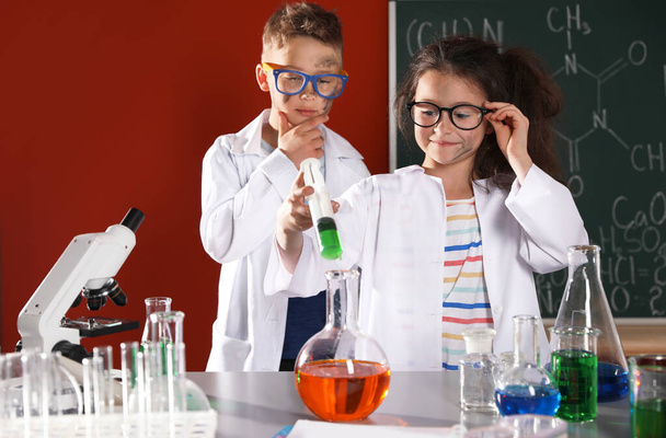 Children doing chemical research in laboratory. Dangerous experiment - Zdjęcie, obraz