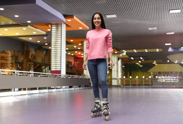 Young woman spending time at roller skating rink - Фото, зображення