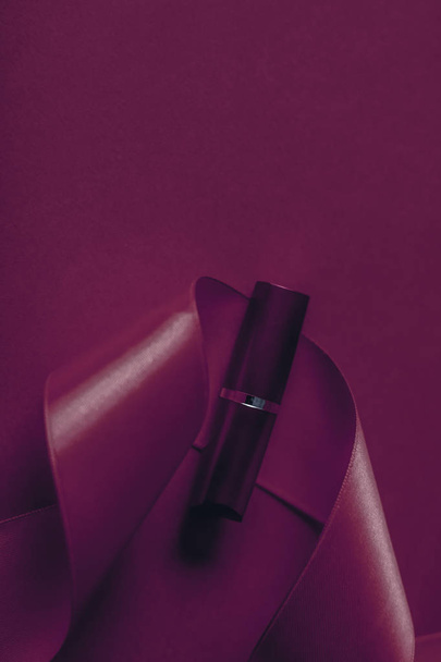 Luxury lipstick and silk ribbon on plum holiday background, make - Foto, Bild