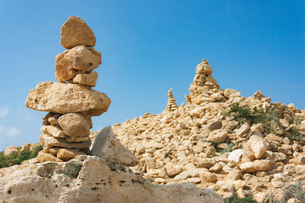 Zen stones are stacked in pyramid on large stone  - 写真・画像