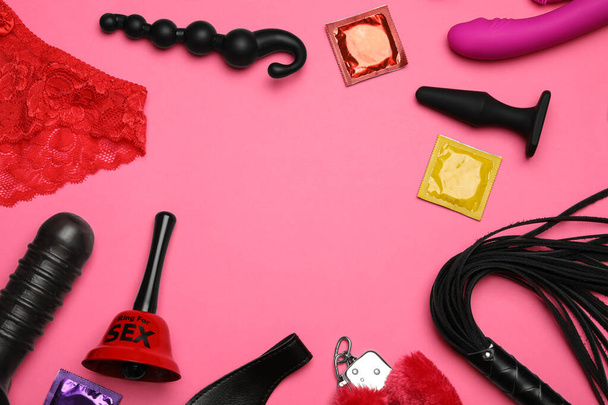 Different sex toys on pink background, flat lay. Space for text - Foto, immagini