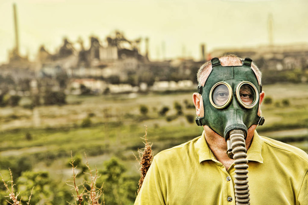 Man in gas mask. Grunge style toned image. - 写真・画像