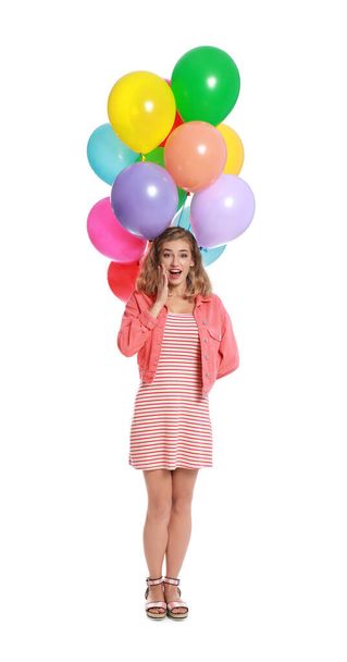 Emotional young woman holding bunch of colorful balloons on white background - Foto, afbeelding