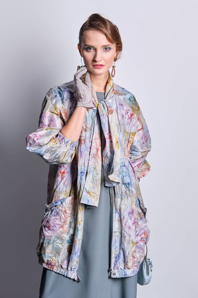 Fashion model in colorful pastel zipper coat and silk dress - Photo, Image