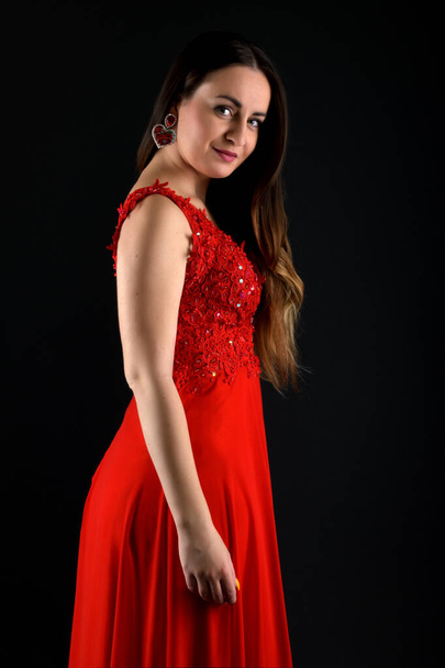 Beautiful fashion woman in red dress. - Фото, изображение