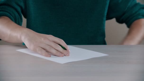 A man is actively writing word on a paper - Video