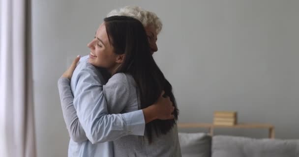 Happy two generation women family embracing bonding greeting - Filmati, video