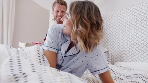 Man bringing sleeping woman breakfast in bed to celebrate birthday or valentines day - shot in slow motion - Footage, Video